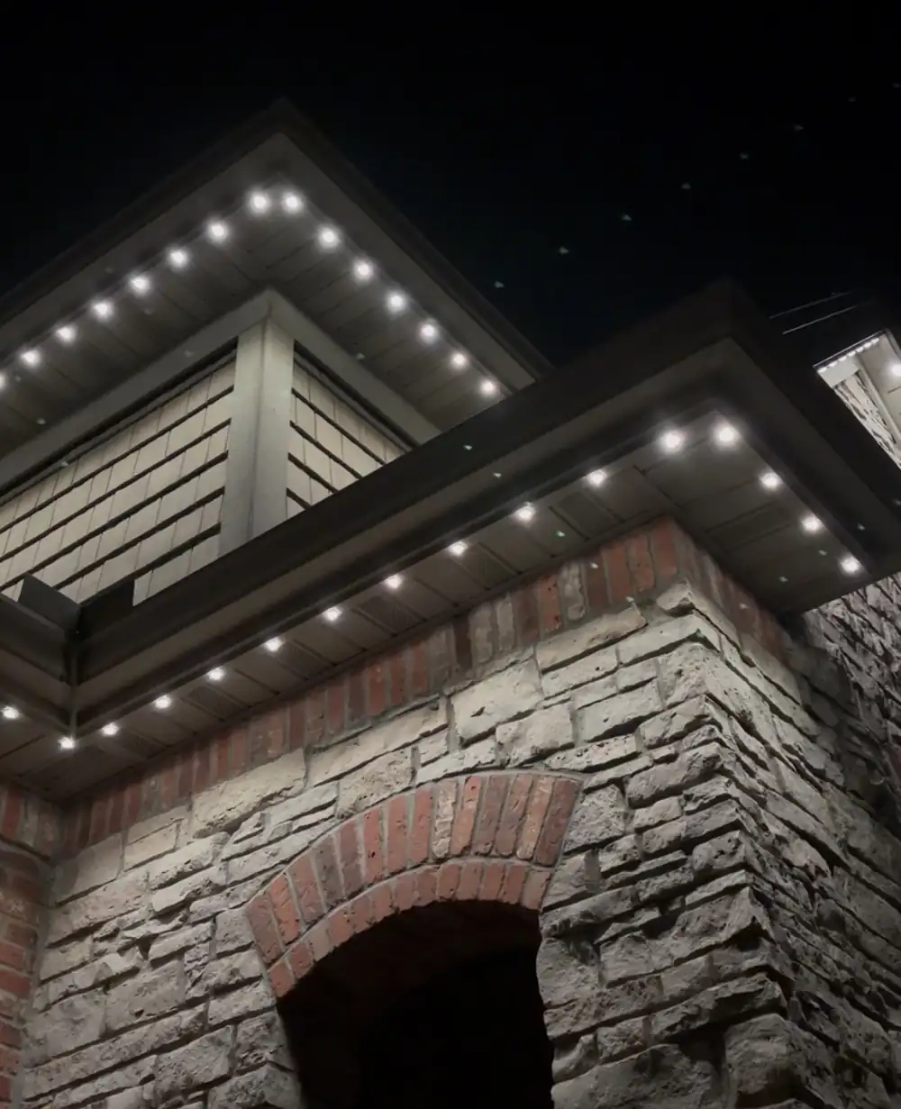 Home with permanent roofline lighting at night